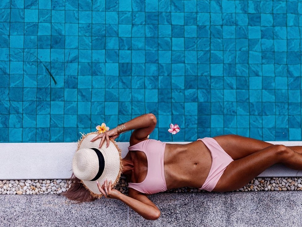 Guest relaxing beside the pool at SEVEN