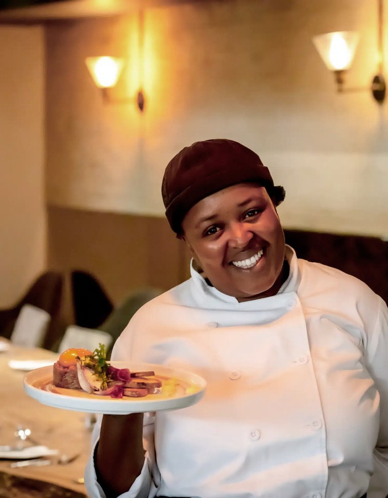 Chef presenting a plated dish at Textures